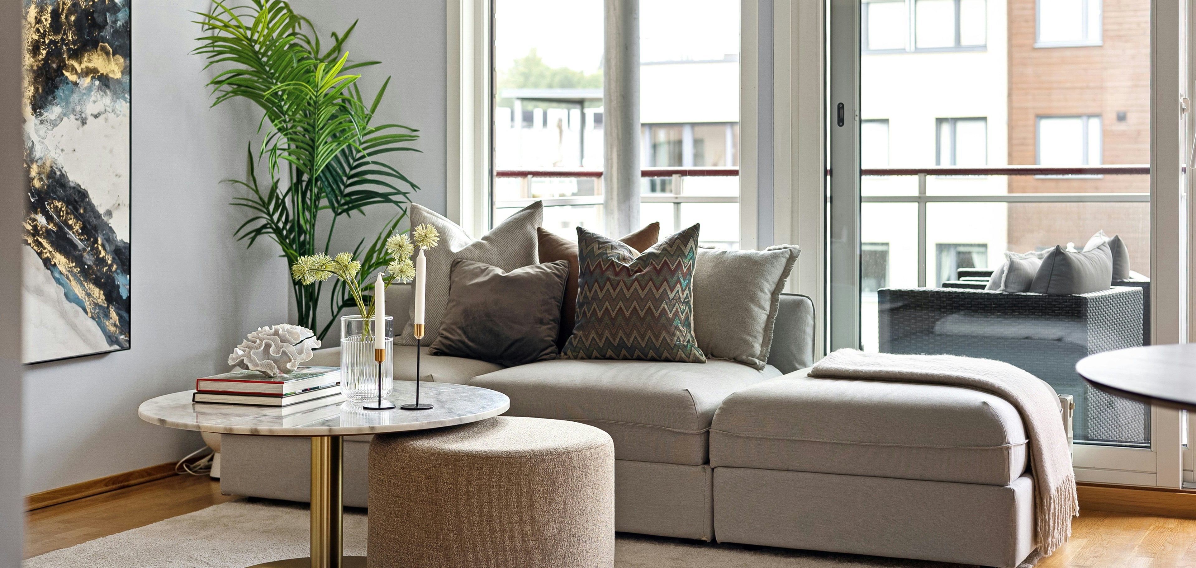 Modern living room with a sectional sofa, coffee table, and decorative items.